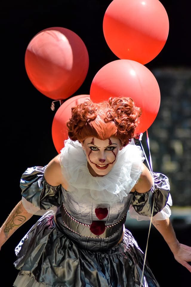 Pennywise costume and makeup with red balloons